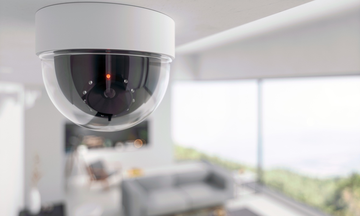 A CCTV camera overlooking a blurred modern living space with ocean view.